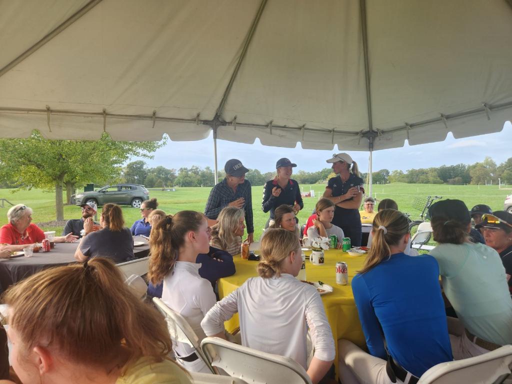 Tent overlooking the cross country course, with tables filled with people