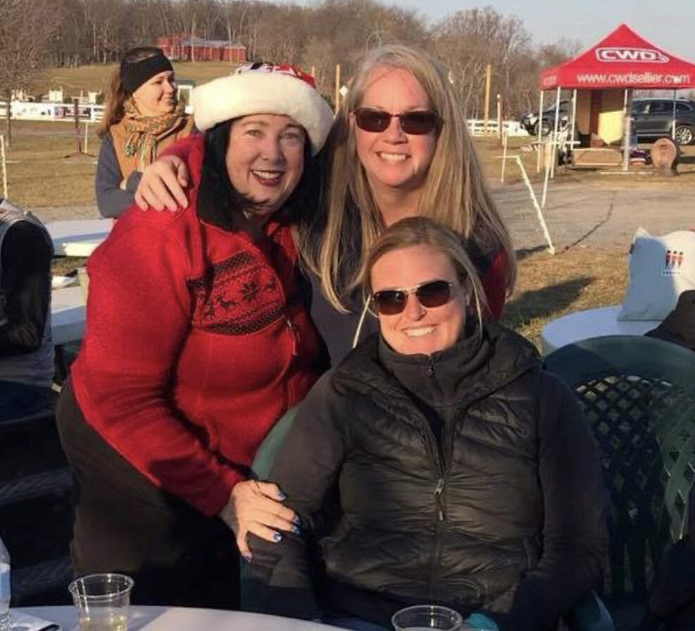 Three women in winter clothing at Loch Moy
